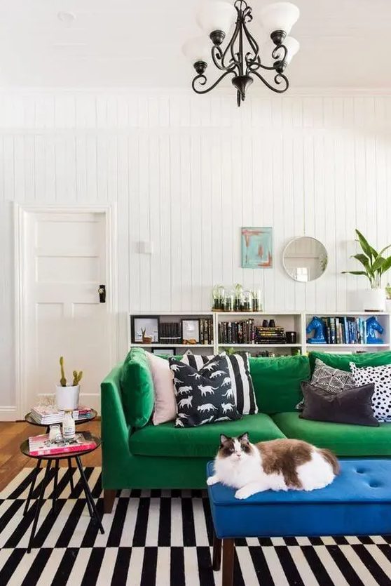an emerald Stockholm sofa and a bold blue upholstered bench to spruce up a monochrome interior