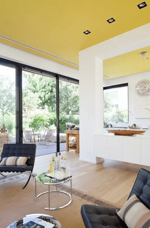 an unexpected sunny yellow ceiling creates a feeling of sunshine in the house everytime you look at it