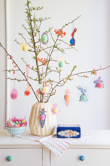 blooming branches with colorful pompom eggs and bunnies are a great Easter centerpiece or decoration to make
