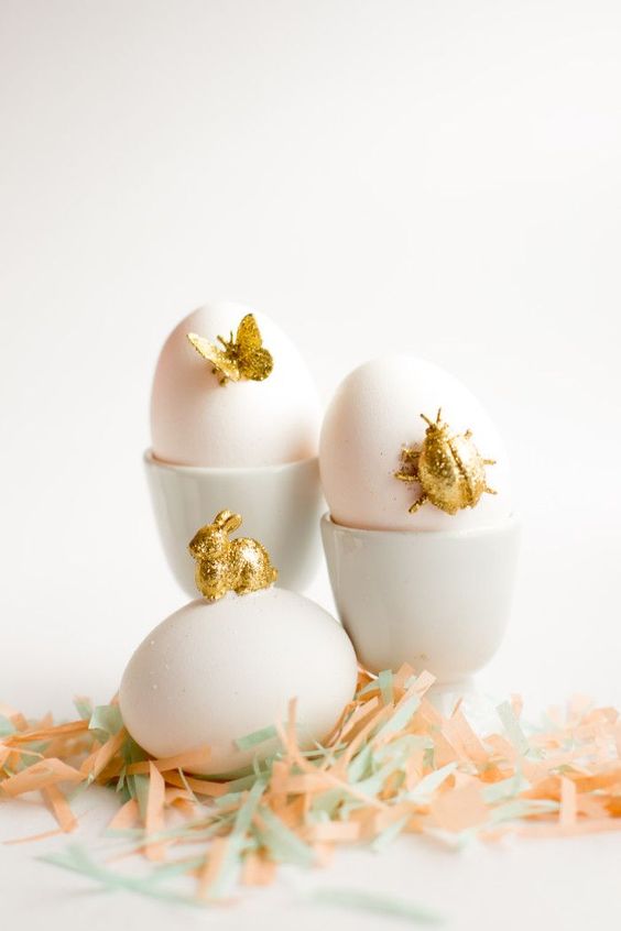 blush Easter eggs accented with gold glitter figurines, bugs, a bunny and a butterfly are amazing for a party