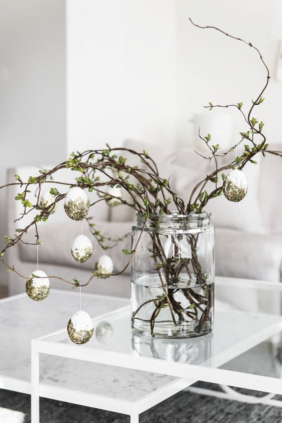 elegant greenery branches with fake gilded eggs are amazing for a modern or Scandinavian space