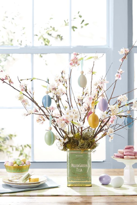 fake cherry blossom branches with pastel Easter eggs are a cool Easter centerpiece to make