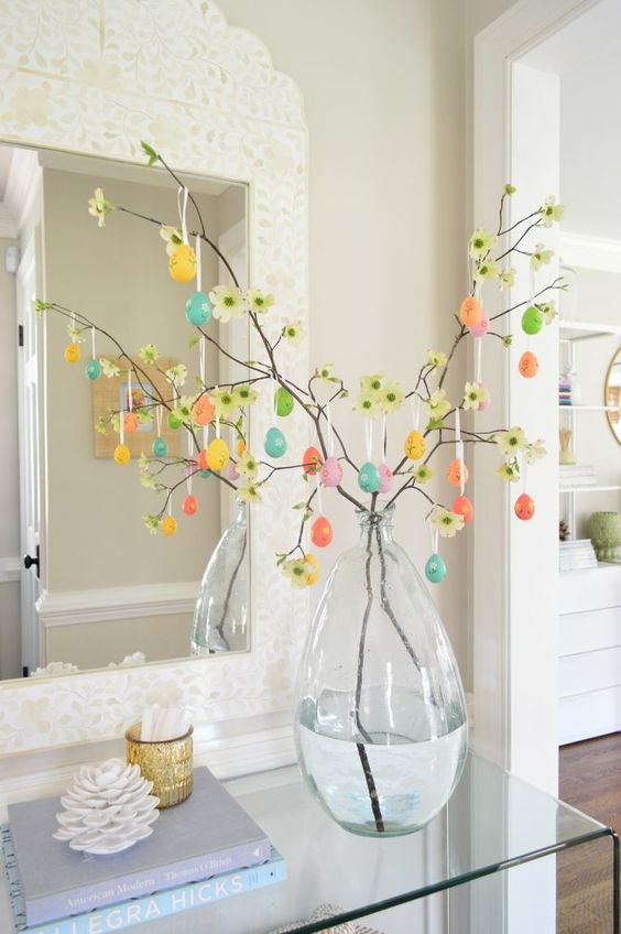 faux blooming branches with colorful plastic eggs are a lovely decoration for spring and Easter that you can make yourself