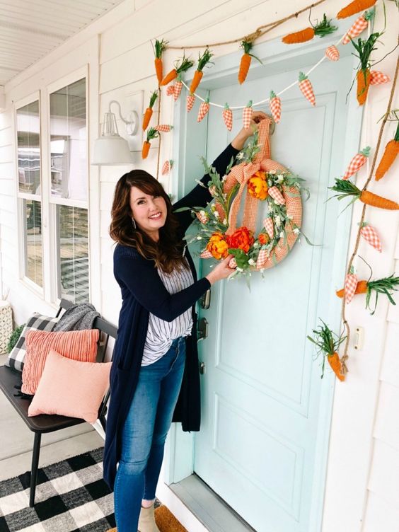 funny carrot garlands and a matching wreath with carrots and faux blooms will make your entrance spring-inspired