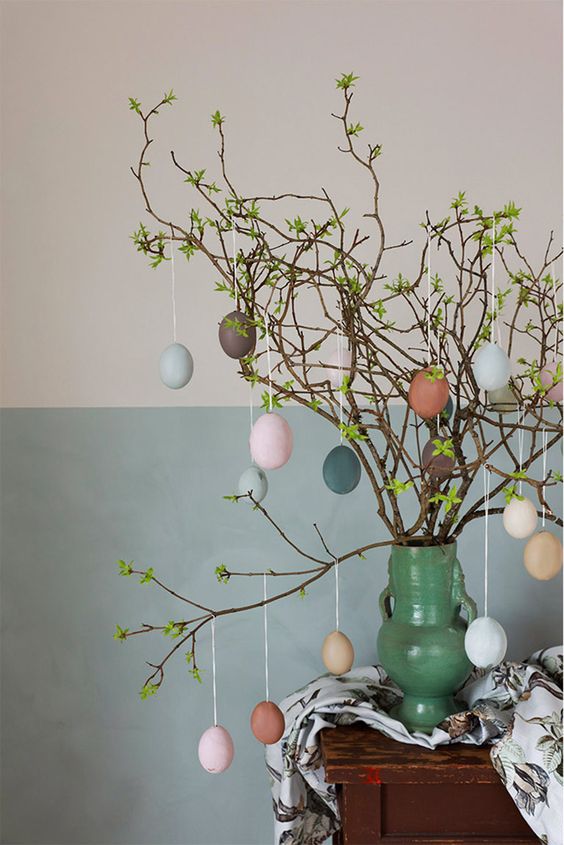 green branches with muted color fake eggs are a cool Easter tree or centerpiece and it's very easy to make