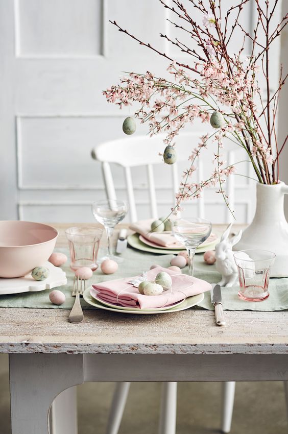 lovely blooming cherry blossom branches with light green eggs are a lovely centerpiece, use it for spring and Easter
