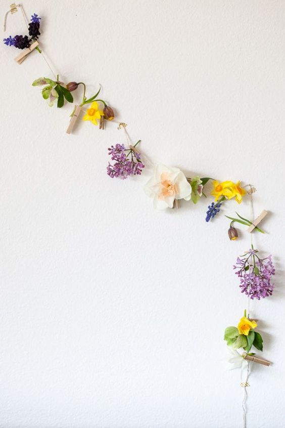 make a simple and quick garland of faux blooms, some twine and clothespins to decorate your space for spring and summer
