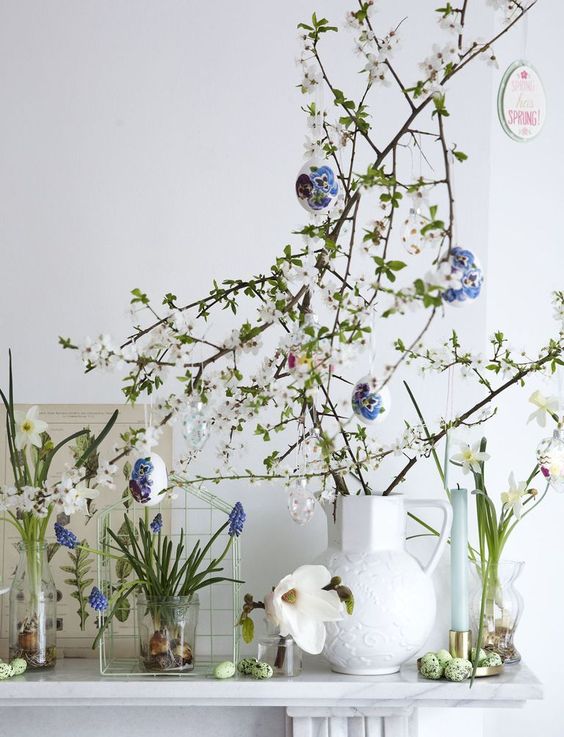 real blooming branches with faux eggs decorated with pansy stickers look absolutely adorable adn very spring-like