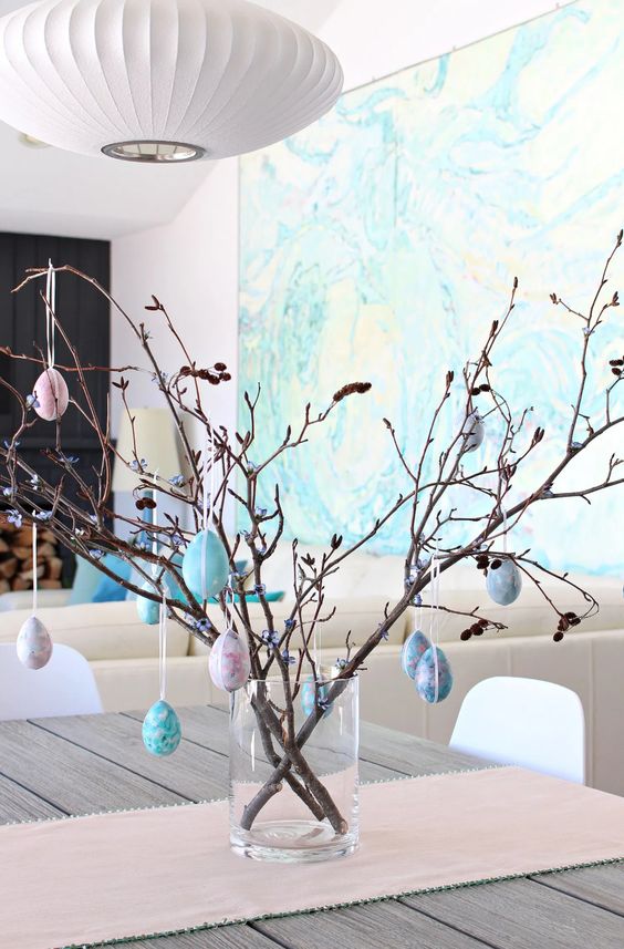 real branches with pastel eggs make up a lovely Easter tree that can be used for decorating all around the house
