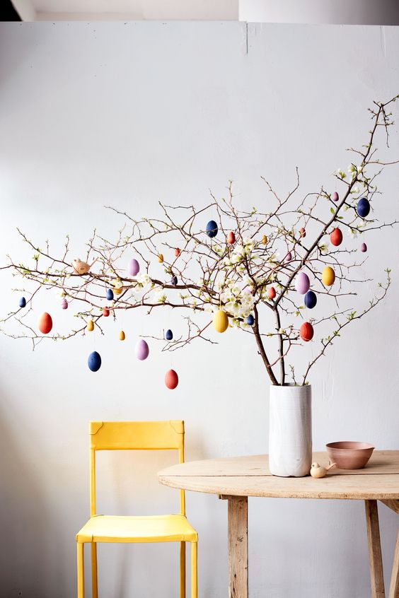 real branches with some blooms and colorful faux eggs are a cool decoratition for Easter