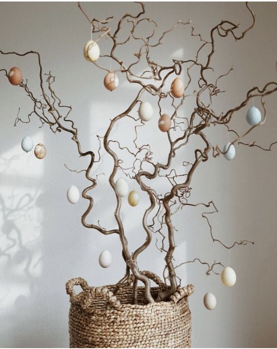 simple branches decorated with tan, neutral and blue plastic eggs are a lovely Easter tree to rock
