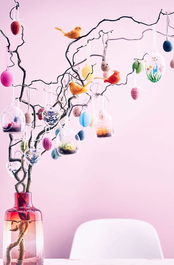 wavy branches decorated with colorful faux eggs and fake birds are a fun and cool decoration for spring and Easter