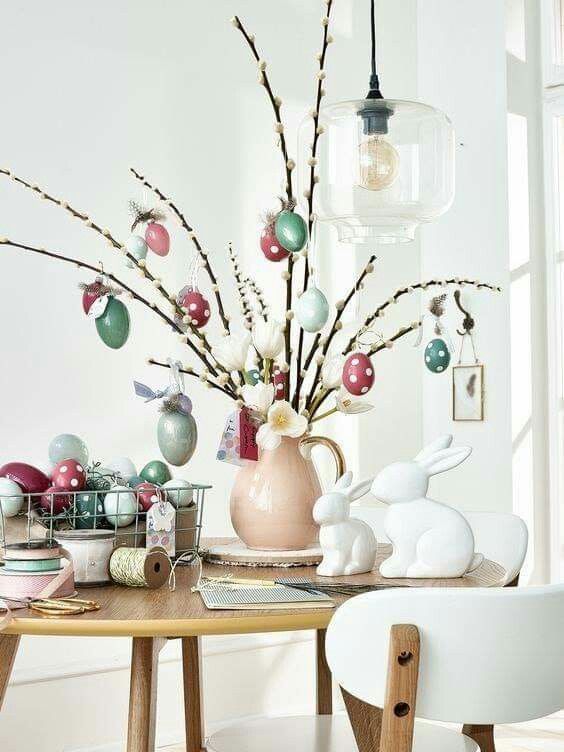 Willow branches with pastel colored fake eggs and some faux blooms are amazing for spring or Easter
