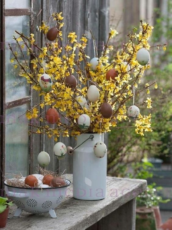 yellow bloom branches with fake eggs in natural colors are a cool Easter tree for a rustic or farmhouse space