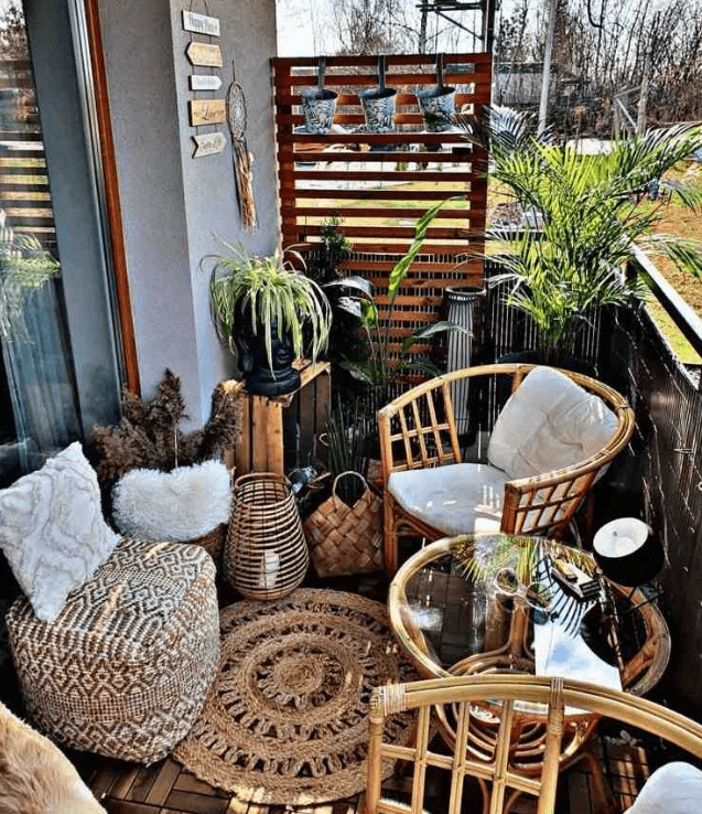 a cute boho balcony with cozy chairs