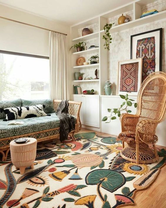 a boho living room with a built-in storage wall unit, rattan furniture with boho upholstery, a bold and fun boho rug plus plants