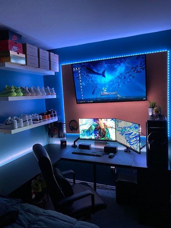 a bold gaming space with a rust accent wall, a TV and screens, a chair, shelves with sneakers to show off the collection