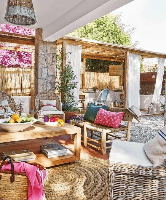 a colorful Mediterranean terrace with bright textiles and rattan furniture, wooden items, colorful accessories and potted greenery
