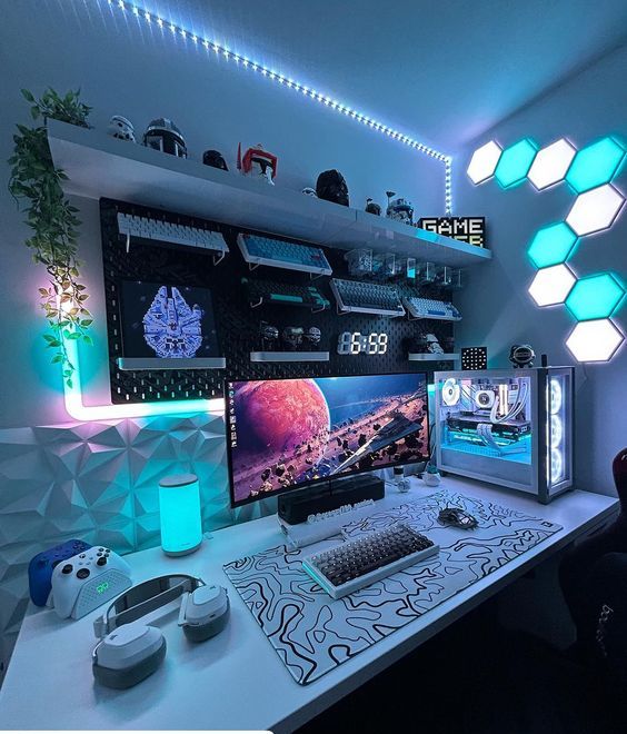 A colorful gaming nook with turquoise and white neon lights, sound proofing panels, a shelf with game inspired decor and a PC