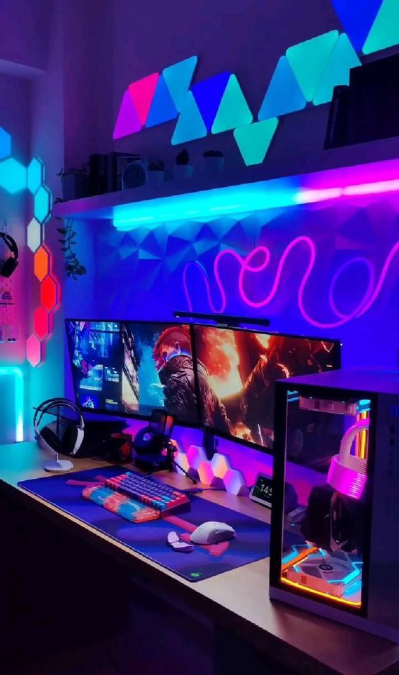 a colorful neon gaming desk setup with bright neon lights of all colors, a PC, some devices and a shelf with decor is amazing