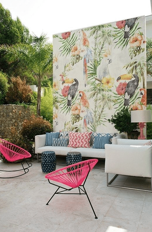a cozy tropical patio with botanical accent wall