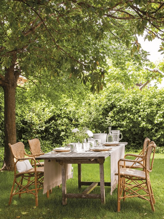 a cute outdoor dining space under a tree