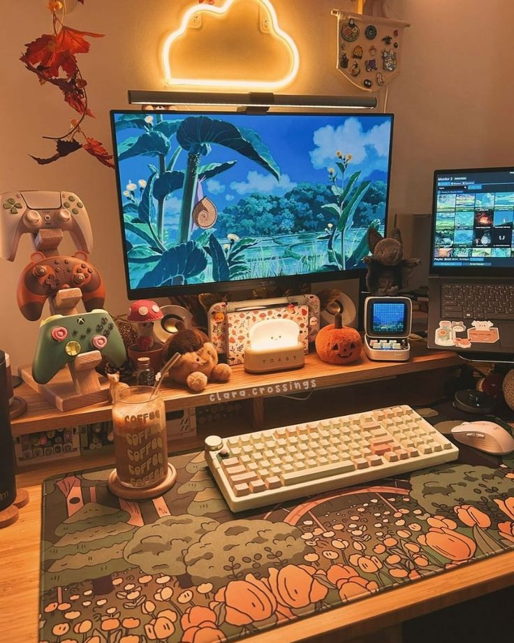 a fall-themed gaming desk setup with a printed desk cover, a PC, some devices, a neon light and cute and pretty lamps