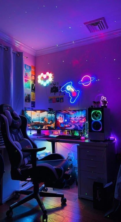 a fun gaming space with colorful neon lights shaped as a controller, a planet and a heart, purple lights, a chair, some PCS and decor