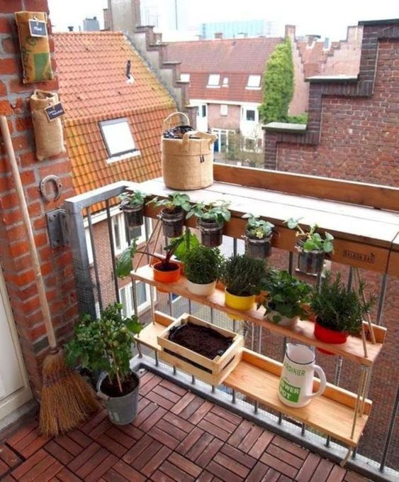 a hanging shelf with potted herbs and some smaller planters attached to railing are a nice idea for a small balcony