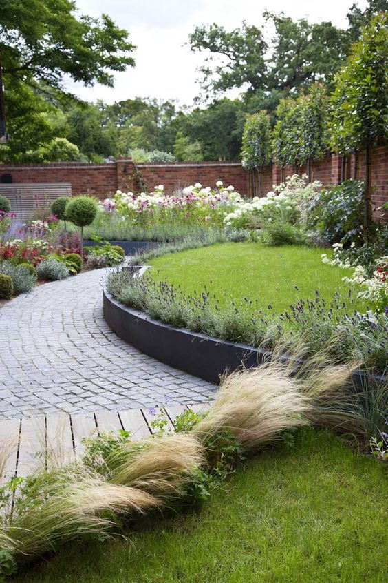 View of a wrap-around garden design in Allison Grove, Dulwich, by Kate Eyre Garden Design