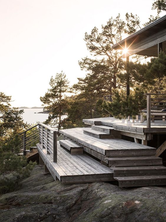 a multi-level deck with some steps and simple furniture is a cool idea for a Scandinavian home