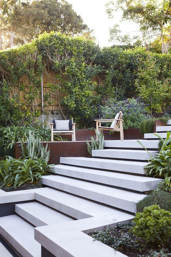 a multi-level modern garden with a large ladder, some greenery, modern furniture is a stylish space