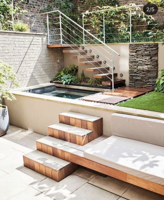 a multi-level outdoor space with greenery, a green lawn, a plunge pool and a tree with built-in outdoor furniture