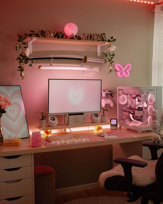 a pink gaming setup with a desk, a cool PC, a chair with faux fur, lights, neon lights and some lamps is amazing