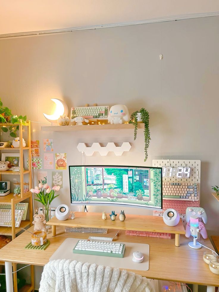 a pretty gaming desk setup with a shelving unit and some shelves, a desk with a stand, some pretty decor and toys and lights and lamps