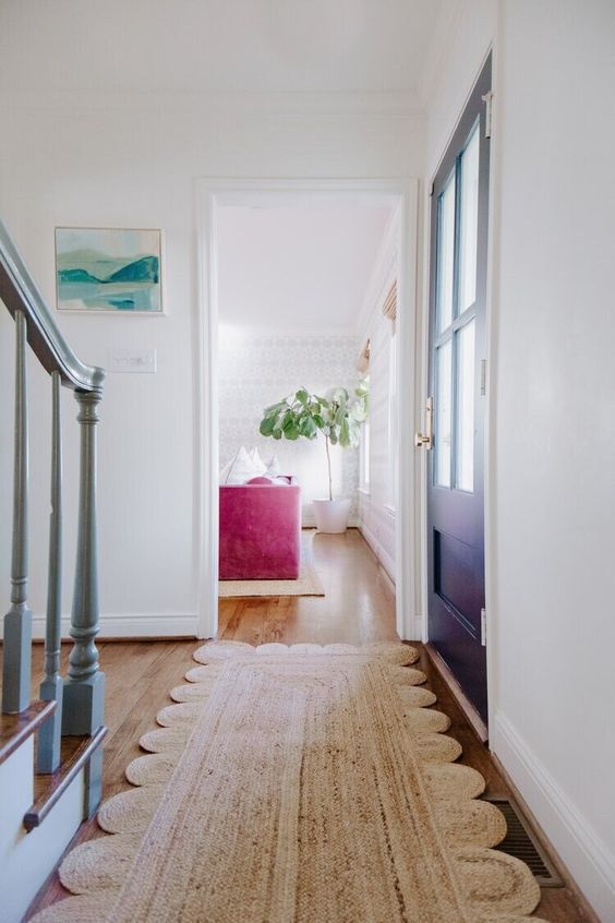 a pretty throw jute rug is a cool addition to an entryway, it's great for many decor styles