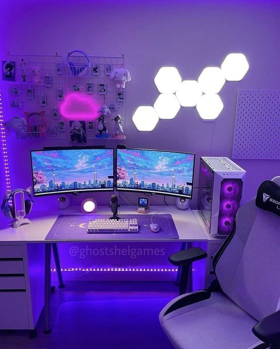 a purple gaming desk setup with a grid with photos, toys and some stuff, a white desk, hex-shaped and cloud-shaped lights on the wall and a chair
