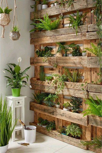 a reclaimed wood vertical garden with planters inserted into pallets is a cool idea for any outdoor and also indoor space