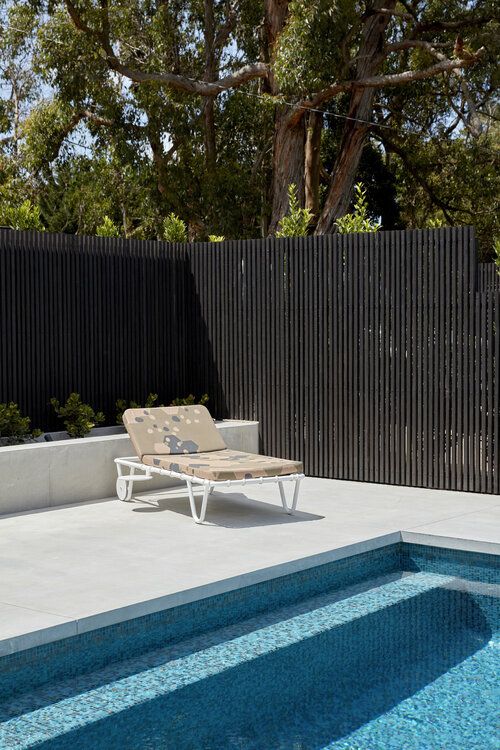 a stylish black pool fence