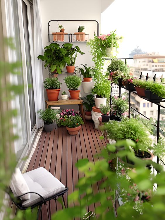 a stylish balcony with railing planters, a stand with some pots with greenery and some planters on the floor