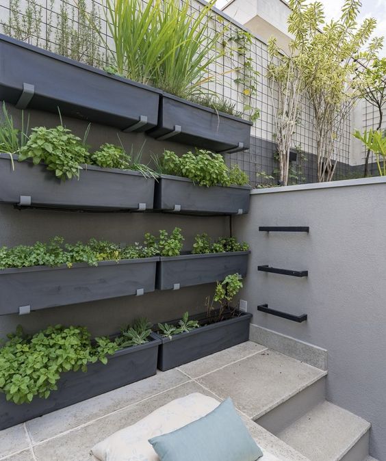 a stylish modern vertical garden with a lot of greenery is a cool solution for a modern, Scandinavian or minimalist space