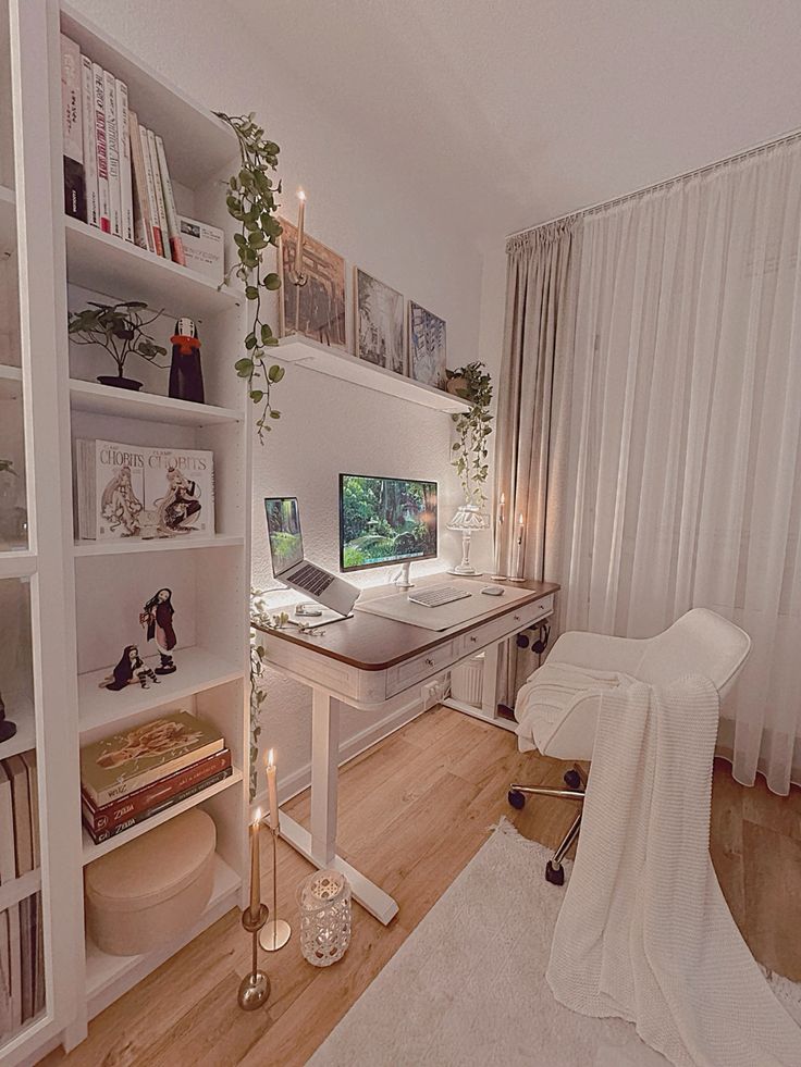 a stylish white gaming desk setup with a shelving unit, a chic desk, a white chair, a shelf with posters, candles and greenery