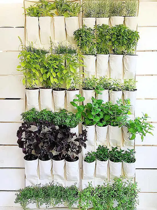 a super simple vertical garden with some pockets with herbs is a cool idea for any garden and any balcony