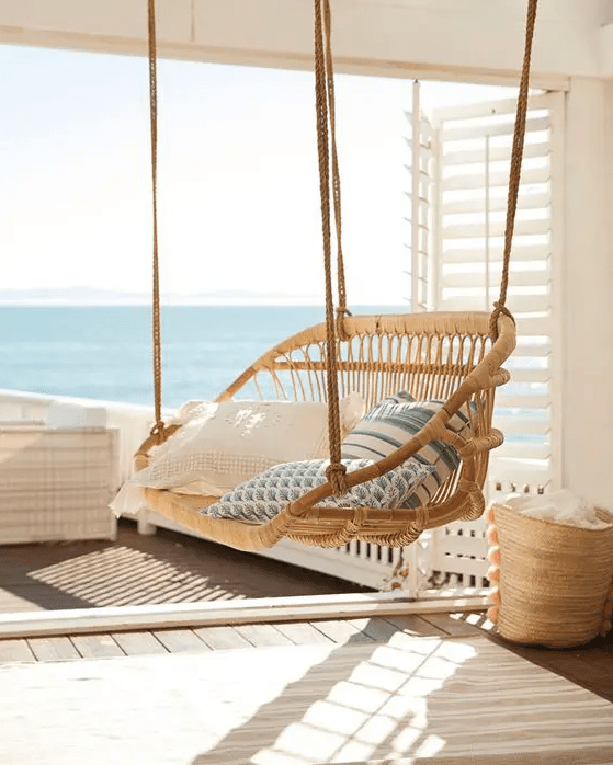 a suspended rattan chair with lots of pillows is always a good idea and it will easily match almost any outdoor space