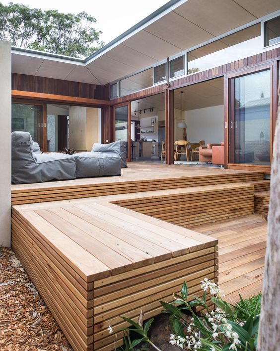 a two-level deck with some outdoor beanbag chairs is a smart solution for a minimalist or contemporary space