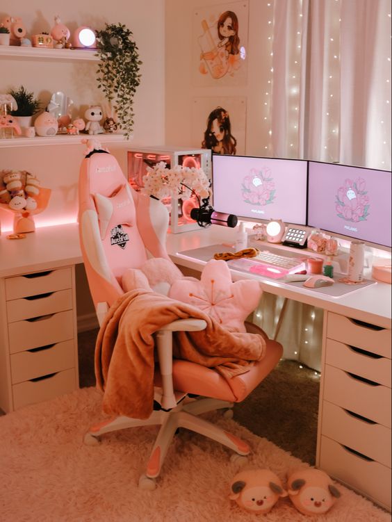 a white and blush gaming desk setup with a chair and a pillow, shelves with decor, a PC, some toys and other cute stuff