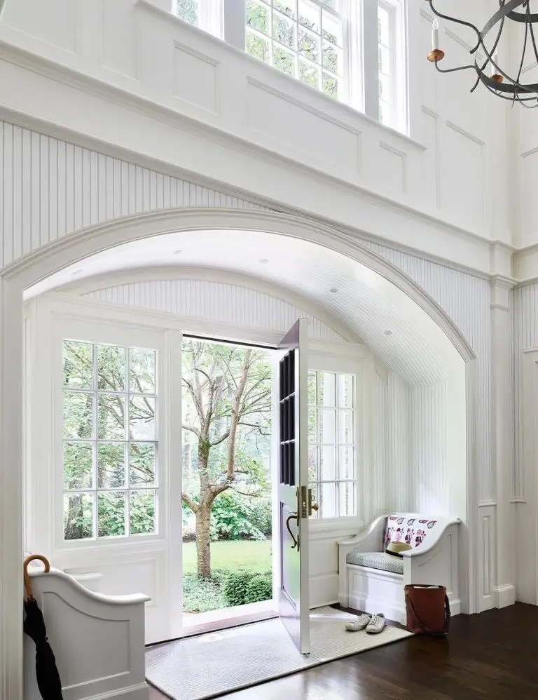 This lovely arched entrance is like a mini drop zone, and this architectural feature is a perfect way to separate the zones.