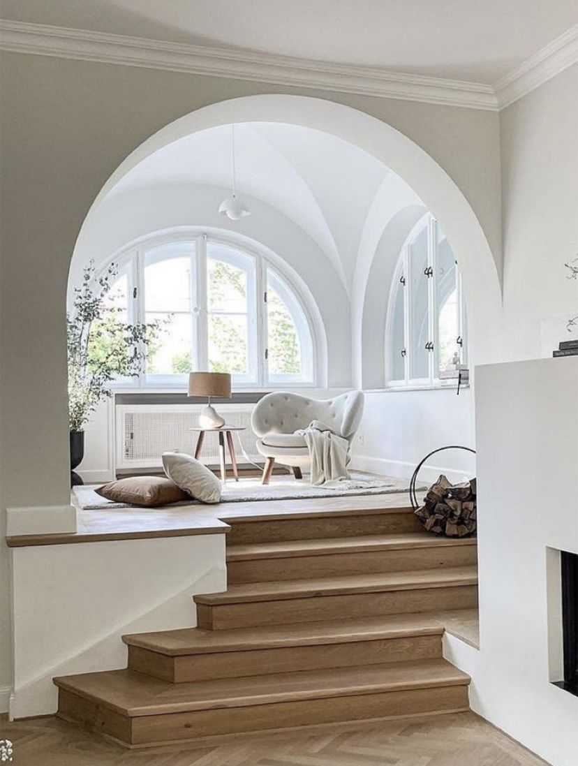 This arched space is filled with natural light and there's a welcoming seating zone to enjoy this light.