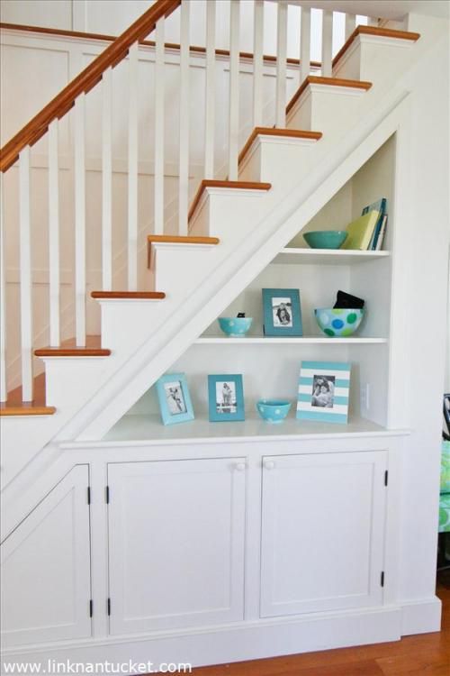 open shelving under the stairs