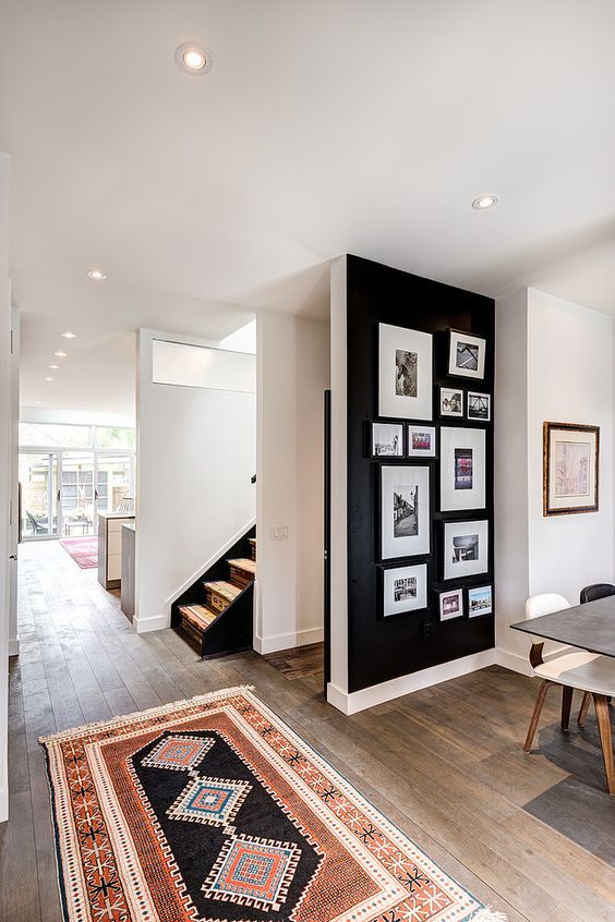 black accent wall with pictures